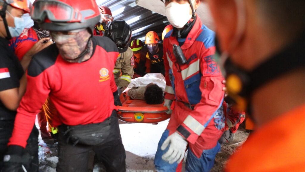 Rescuers chip away debris with hand tools to save those trapped in Indonesia school collapse